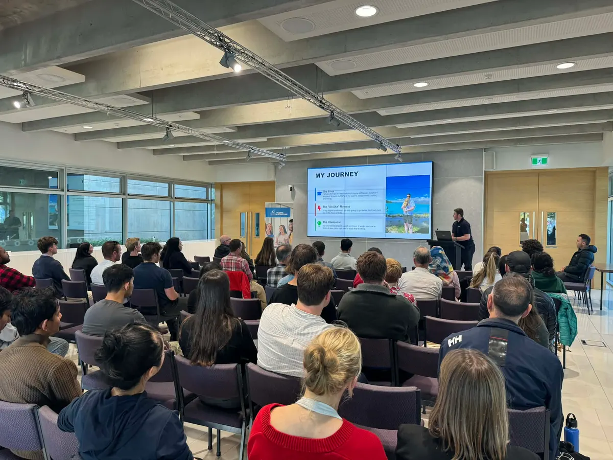 A full room at the University of Canterbury watching Blake Harkness present his My Journey slide at Graduating into a World of AI