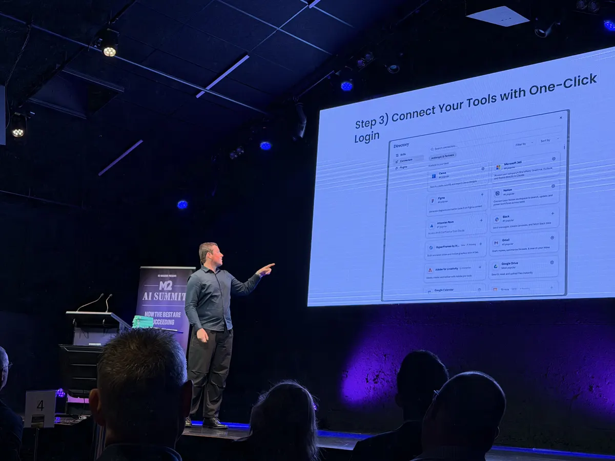 Blake Harkness pointing to the slide Step 3: Connect Your Tools with One-Click Login during his live Claude demo at the M2 AI Summit